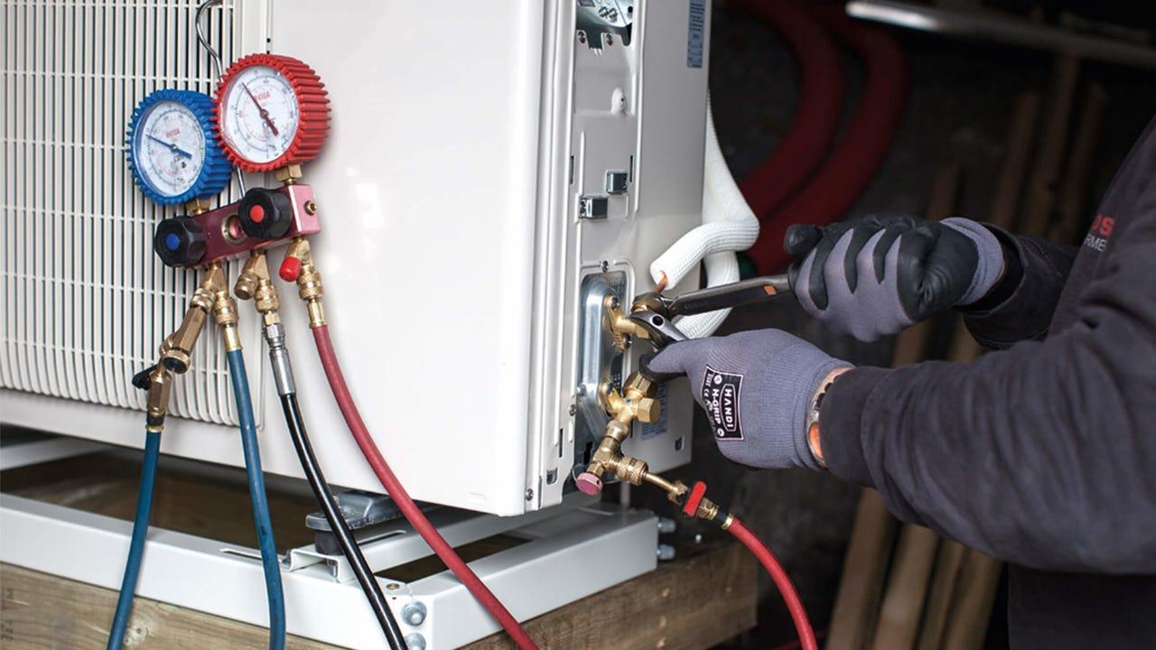 Close-up of pressure gauges hoses servicing high-efficiency heat pump connections